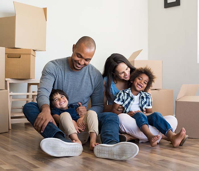 family on floor hugging